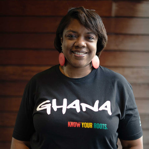 African American woman wearing a Ghana T-shirt with the text "Ghana" and "Know your roots"