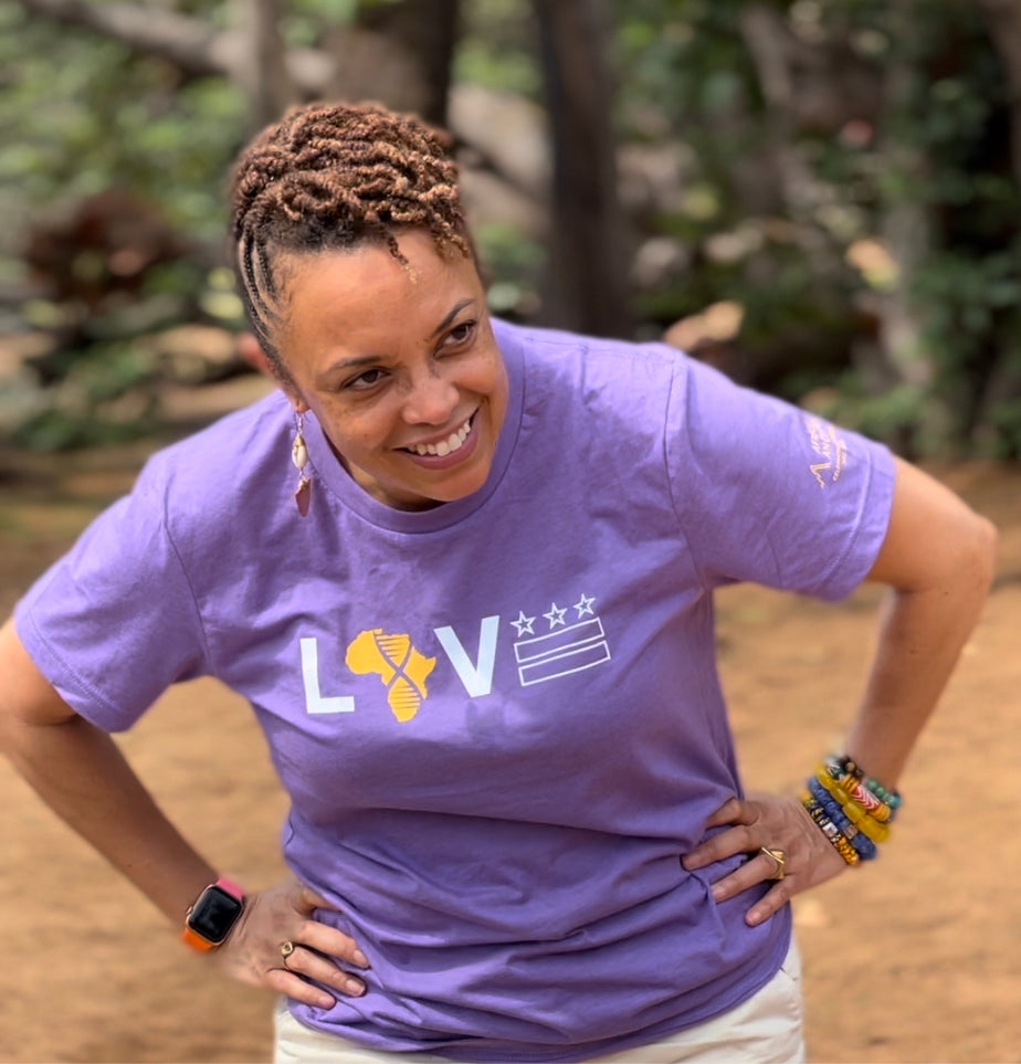 Gina Paige wearing a purple love Tshirt that displays the african continent and the Washington D.C. flag